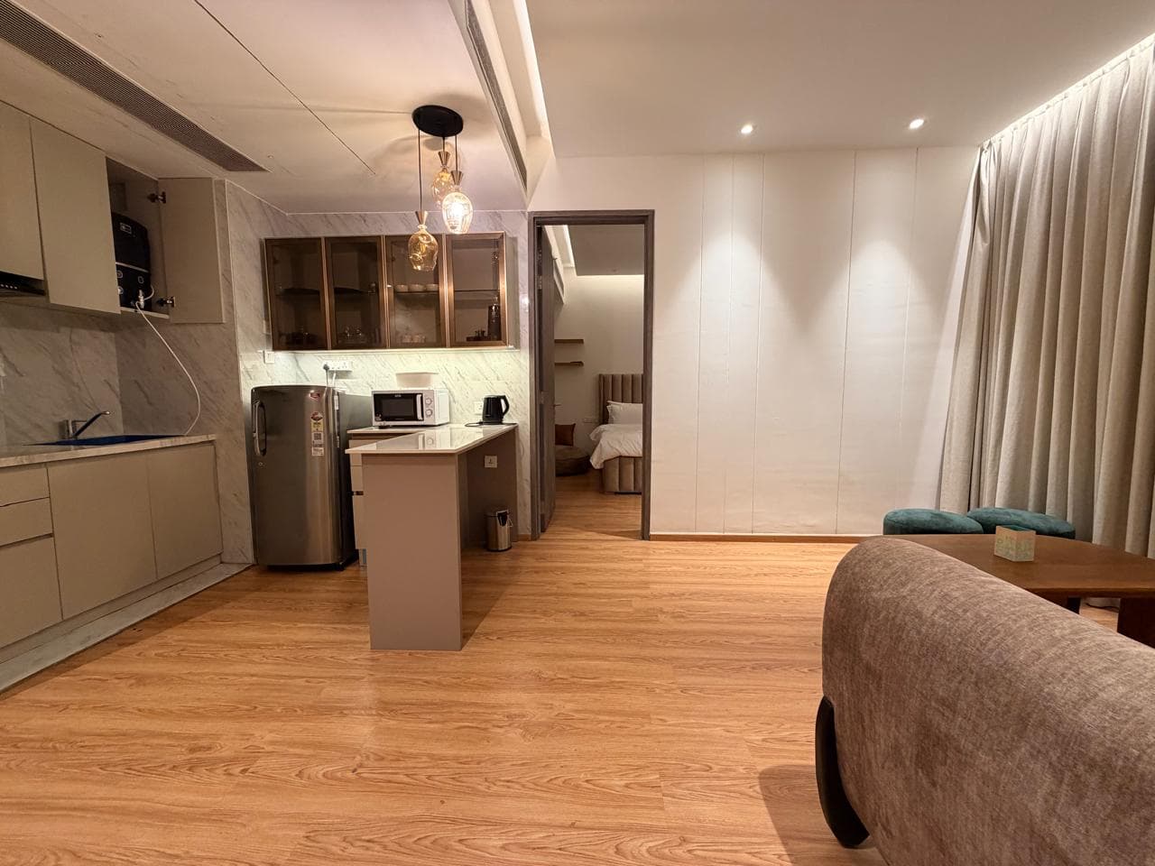 Living and dining room of a 2 BHK serviced apartment at M3M Urbana, Gurgaon